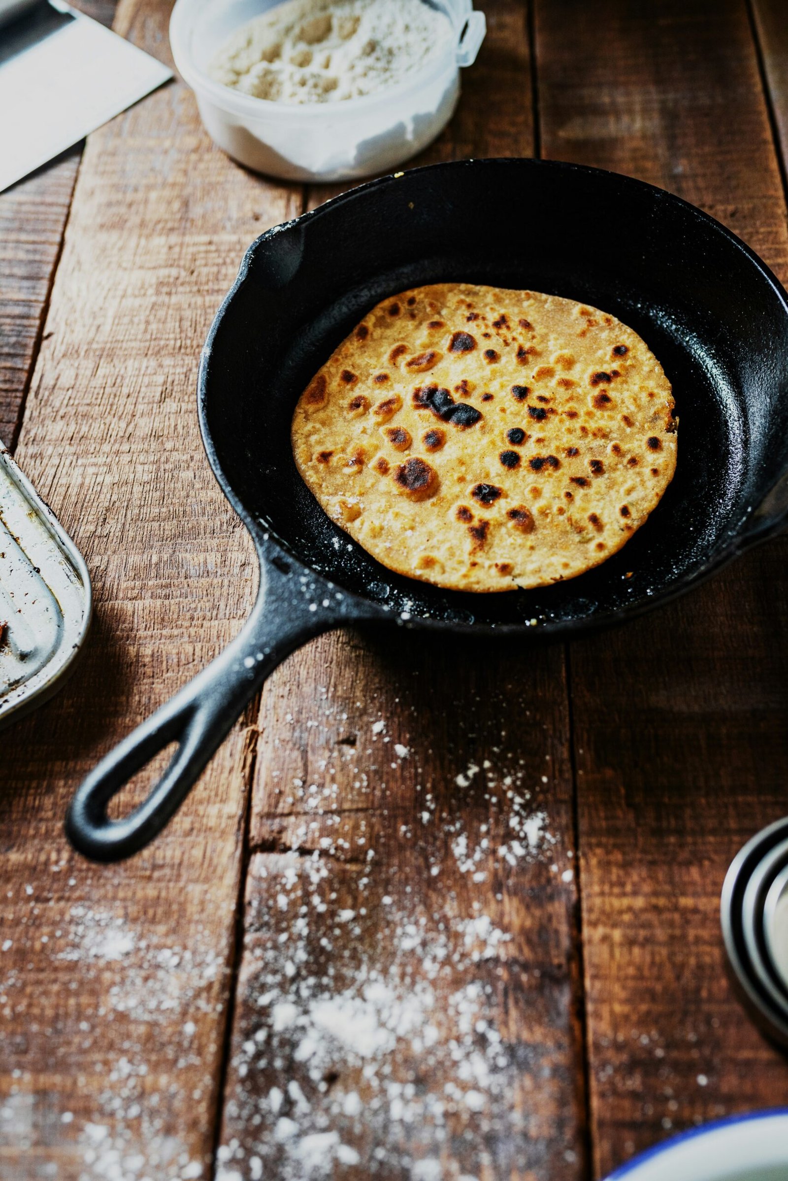 black frying pan on brown wooden table